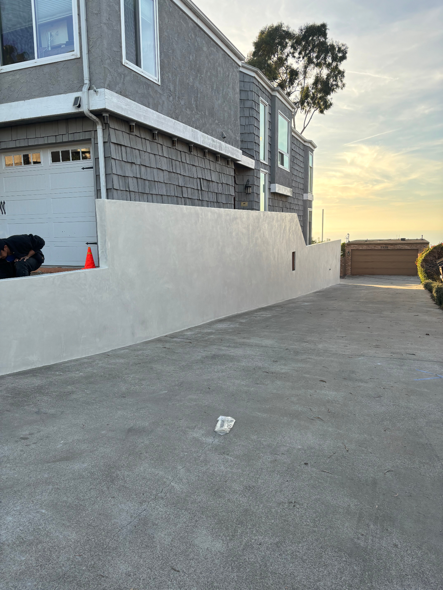 Hillside Stucco Wall & Concrete Driveway
